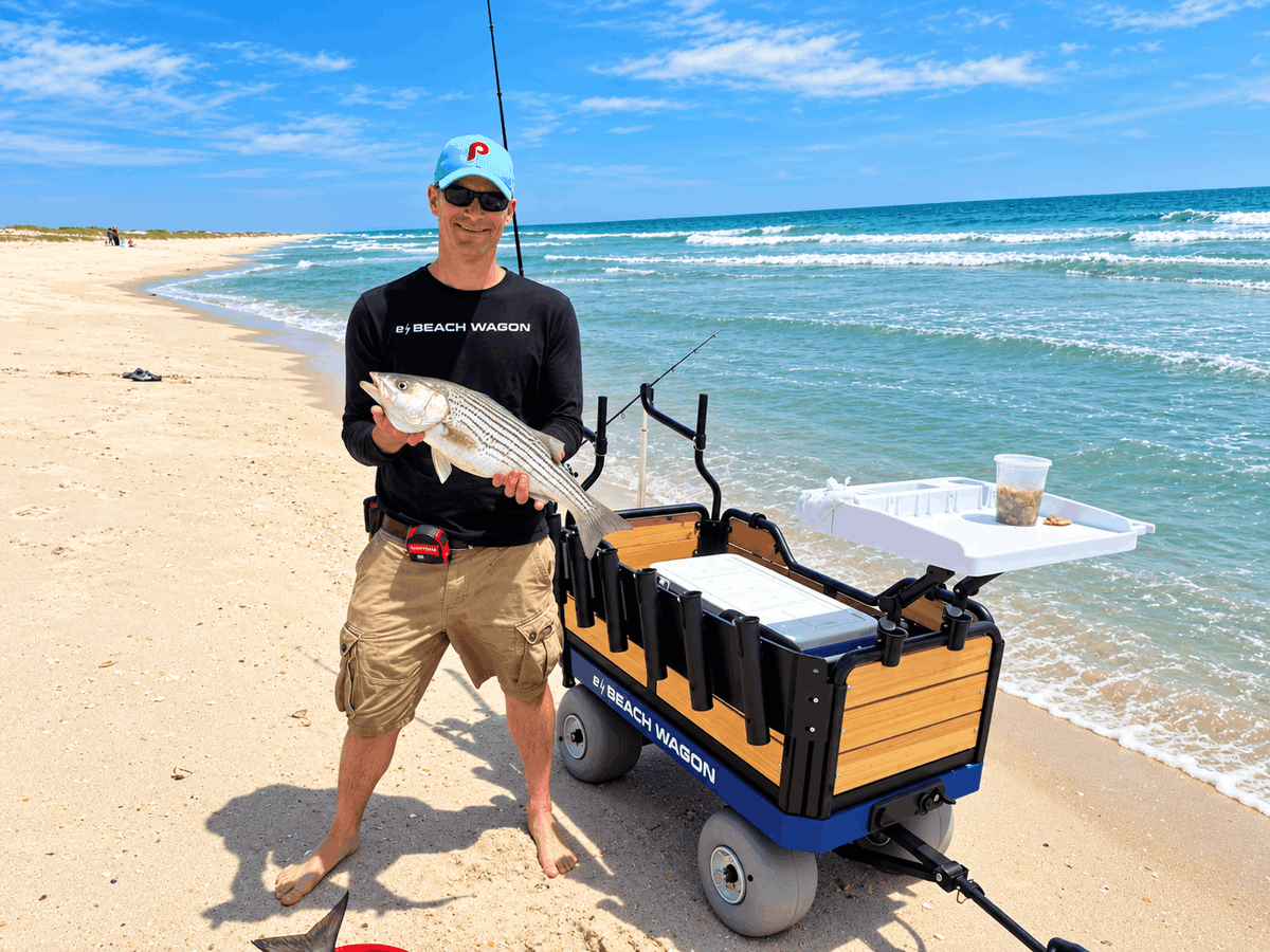 e-Beach Wagon, a powered motorized cart, in action on the beach with fishing accessories: 6-rod fishing rack and fillet board. Built for soft sand and fishing days