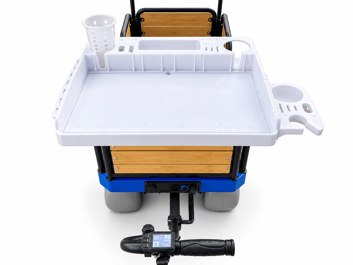 A large white plastic fillet board with cup holder mounted on an e-Beach Wagon, a powered beach fishing cart