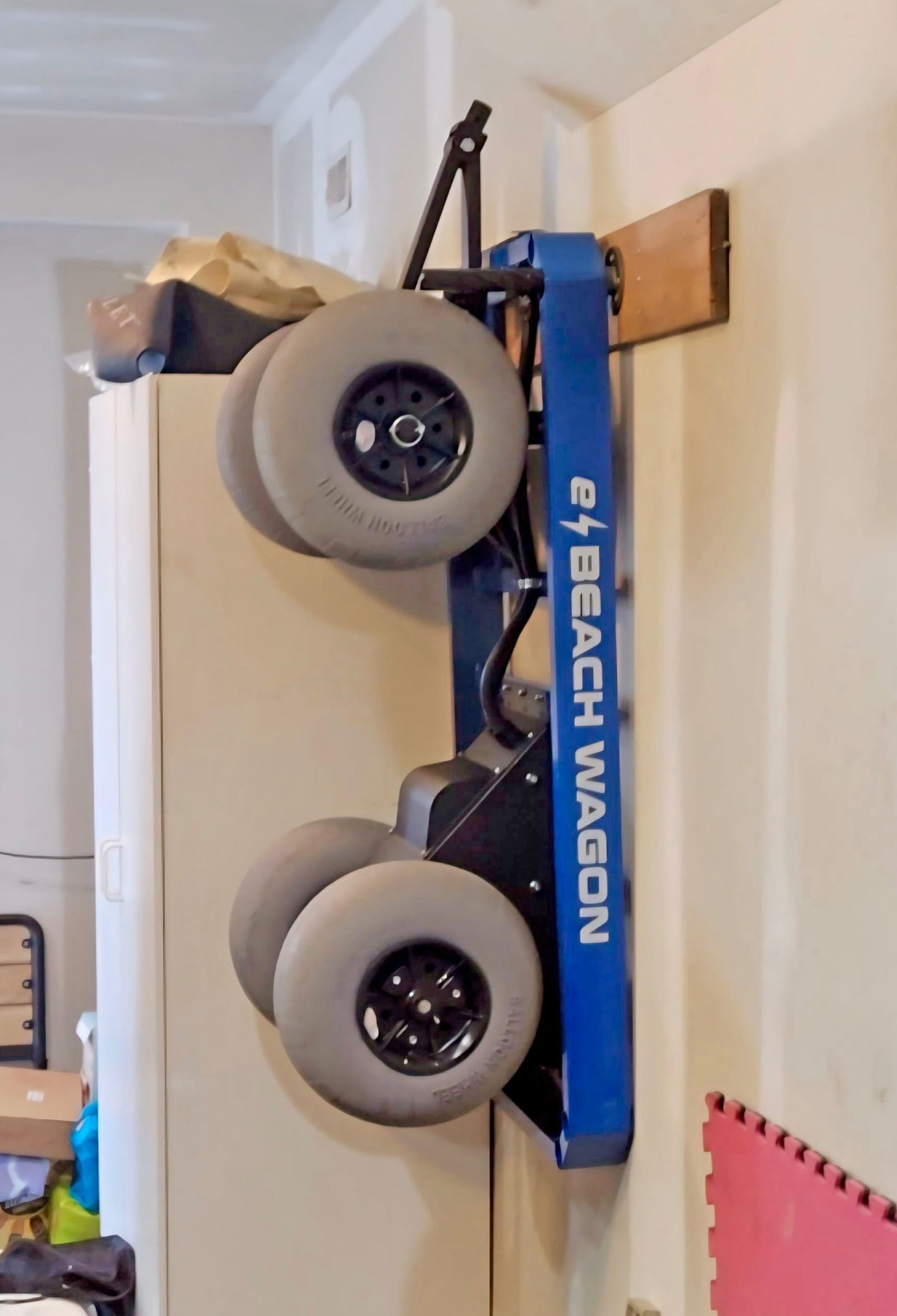 e-Beach Wagon stored upright on wall in beach garage