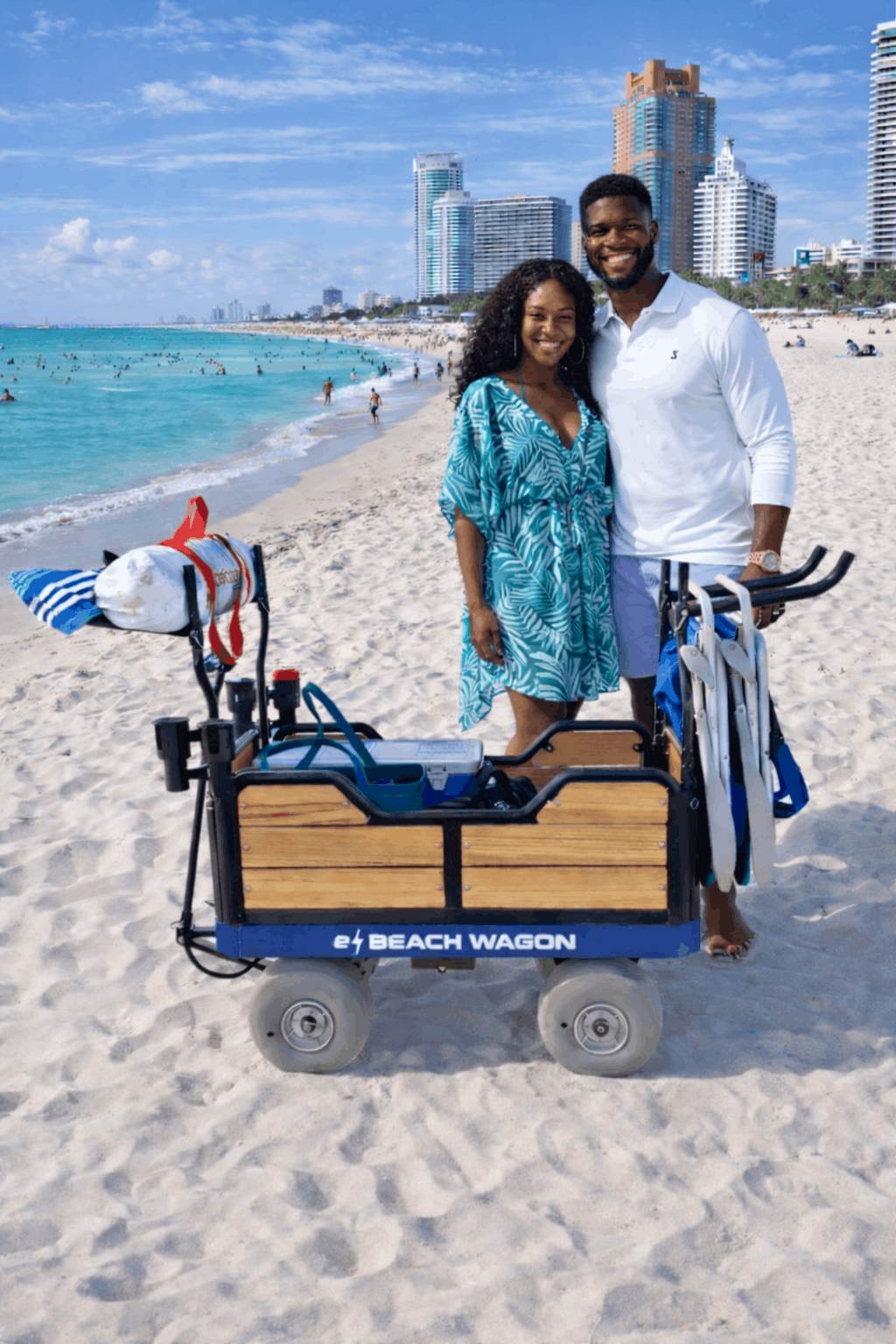 Couple in Miami, Florida posing happily by their motorized powered e-Beach Wagon