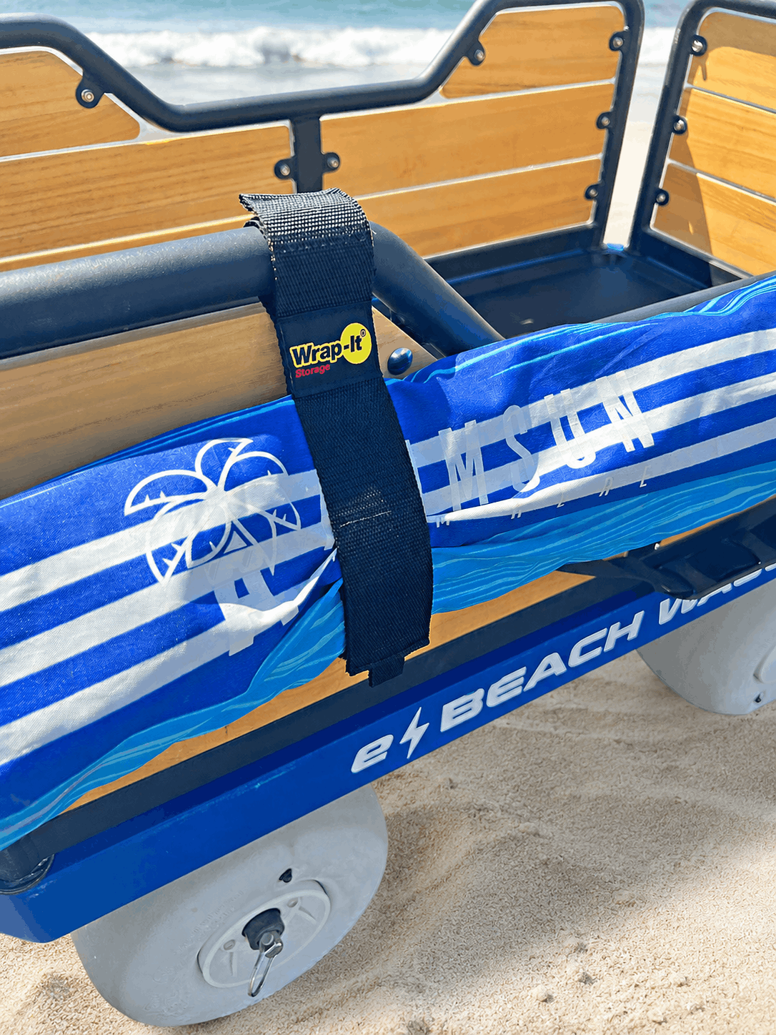 e-Beach Wagon with a blue and white striped beach umbrella strapped with a Wrap-It Twin-Wrap