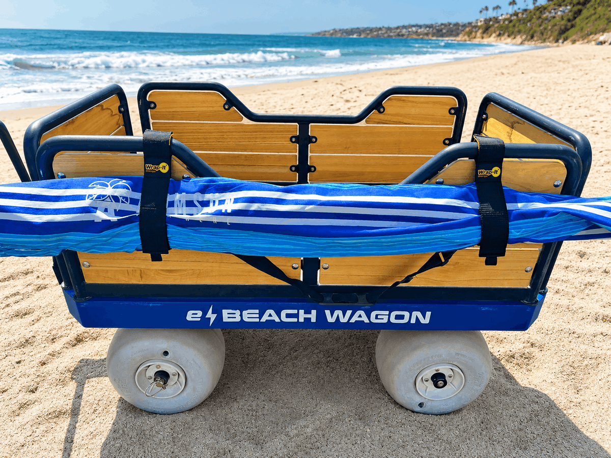 e-Beach Wagon with wrap-it straps attached holding a beach umbrella on the side